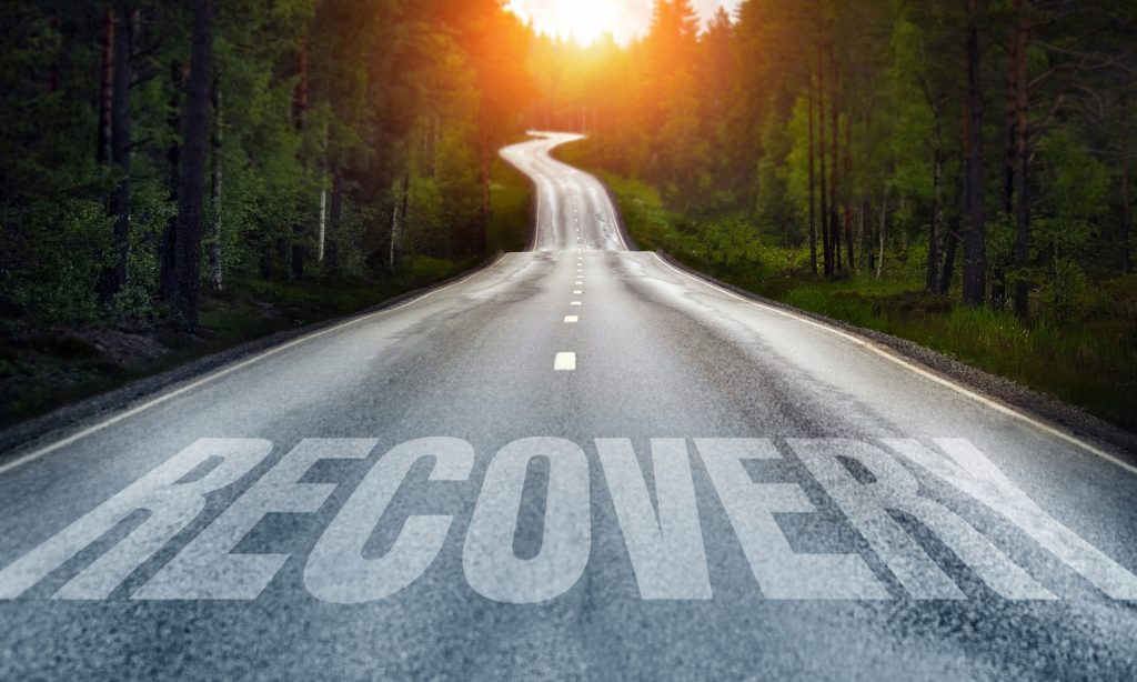 a road with recovery written on it
