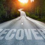 a road with recovery written on it