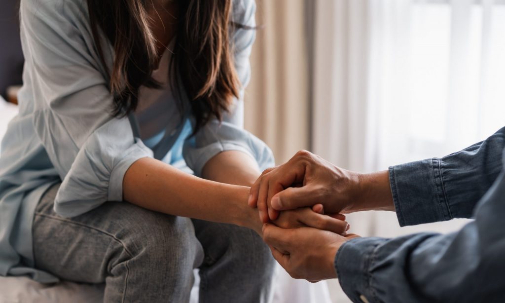 person talking to a loved one about treatment